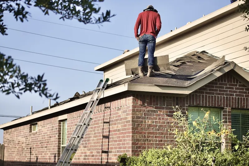 Professional roofer working on a residential roof in Baywood